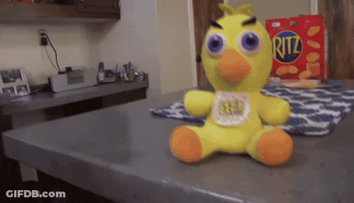 Stuffed Yellow Duck Next To Ritz Chips Box GIF