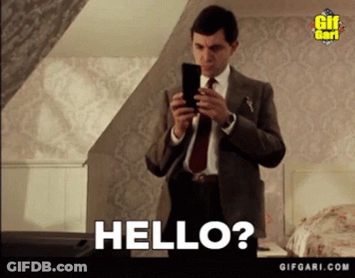 Suit And Tie Man Holding Cell Phone Saying Hello GIF