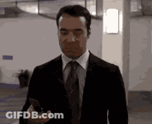 Suit And Tie Man Holding Phone Walking GIF