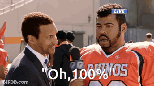 Suit And Tie Man Talks To Bulldogs Fan GIF
