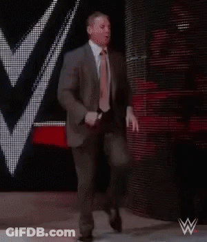 Suit And Tie Man Walking Down Stage GIF