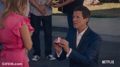 Suit Man Proposing Woman Pink Dress Netflix Logo GIF