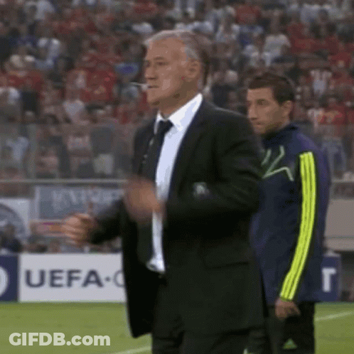 Suited Man At UEFA Sign On Soccer Field GIF
