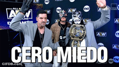 Suited Man Holding Wrestling Championship TNT Logo GIF
