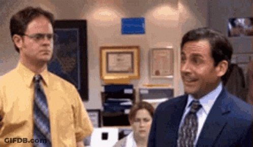 Suited Man Next To Man In Yellow Shirt GIF