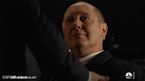 Suited Man Shaking Hands With NBC Logo GIF
