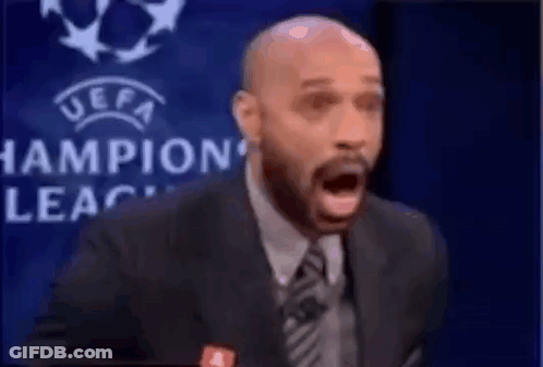 Suited Man Speaking Into Microphone With Champions League Logo GIF