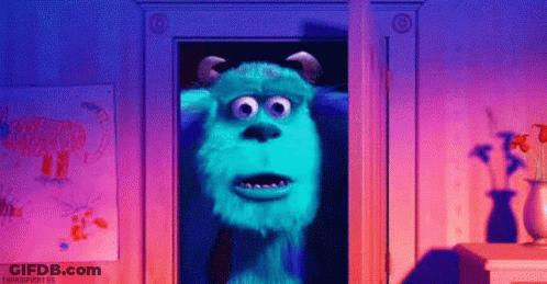 Sulley From Monsters Inc Is Standing In A Doorway In A Room . GIF