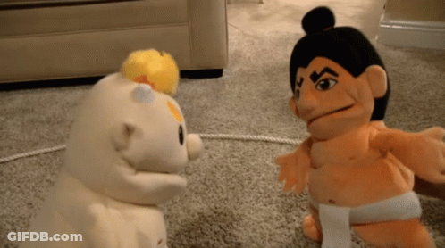 Sumo Wrestler Puppet Standing Next To Another Puppet GIF