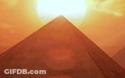 Sun Setting Behind Pyramids In Desert GIF