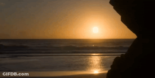 Sun Setting Over Ocean Waves GIF