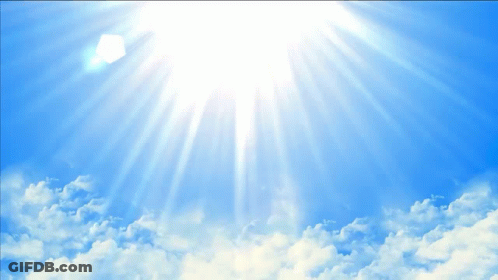 Sun Shines Brightly Through Clouds In Blue Sky GIF