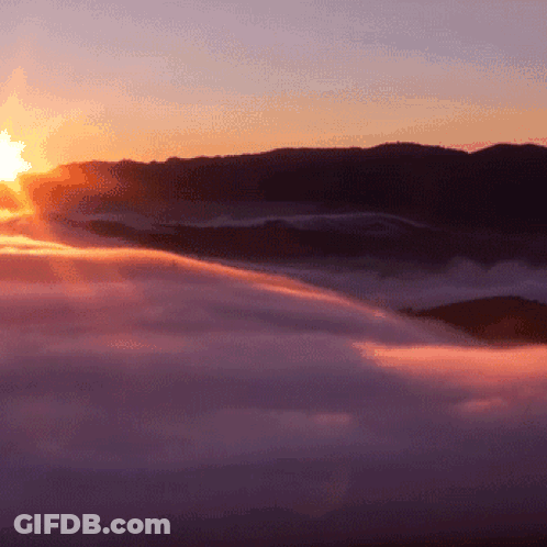 Sun Shining Through Clouds In Mountains GIF