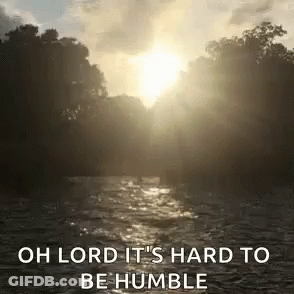 Sun Shining Through Trees Over Water Saying Oh Lord It's Hard To Be Humble GIF