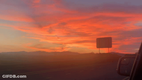 Sunset Over Highway With Mountains GIF