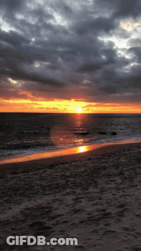 Sunset Over Ocean With Few Clouds GIF