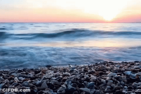 Sunset Over Rocky Beach Water GIF