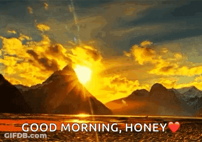 Sunset Through Clouds Over Lake And Mountains GIF
