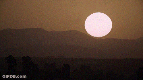 Sunset With Mountains And Large Pink Sun GIF