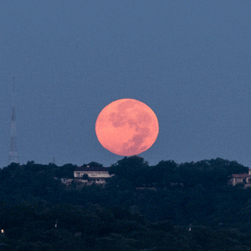 Super Moon Disappearing Behind Peaks GIF