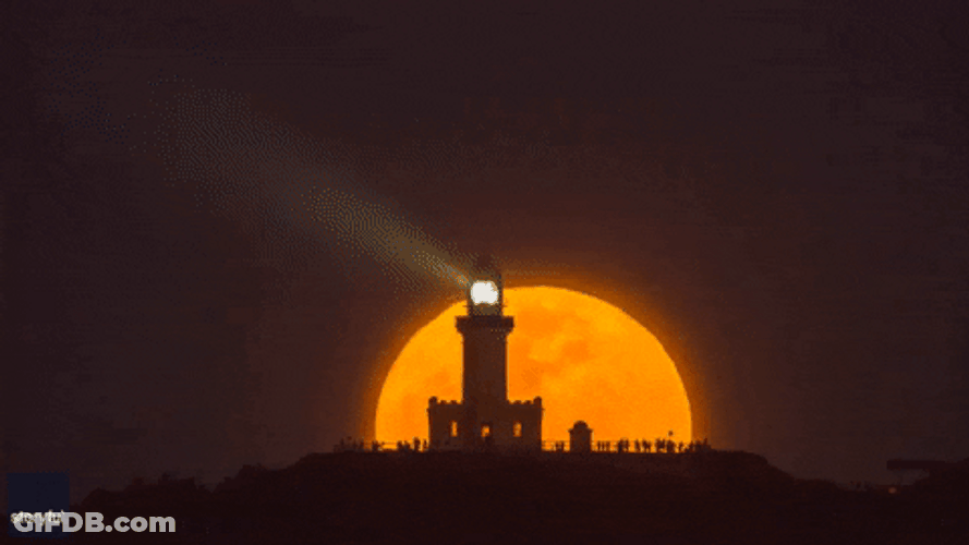 Super Moon Rising Behind Lighthouse GIF