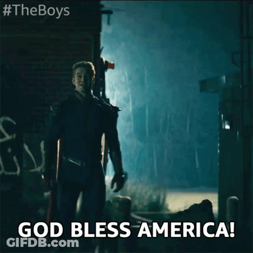 Superhero In Dark Alley Saying God Bless America GIF