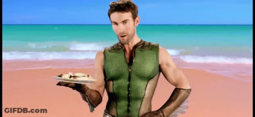 Superhero Man Holding Food On Beach GIF