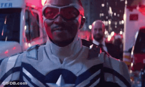 Superhero Man In Front Of Ambulance At Night GIF