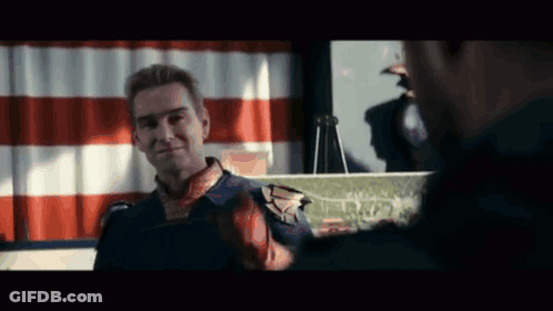 Superhero Talking To Man In Front Of Flag GIF