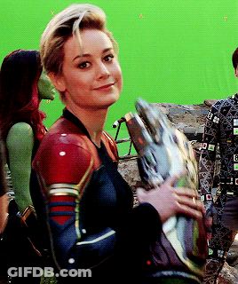 Superhero Woman Holding Helmet Smiling GIF