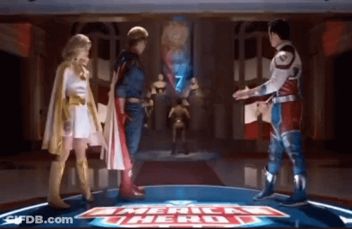 Superheroes Standing In Front Of American Hero Sign GIF