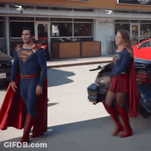 Superman And Supergirl Standing Together GIF
