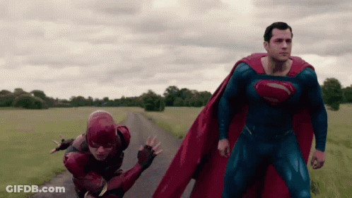 Superman And The Flash Are Running Down A Road In A Field GIF