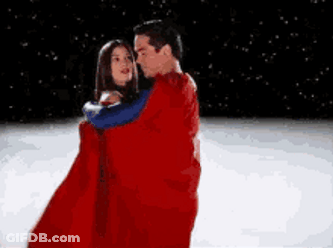 Superman Hugging A Woman With His Cape GIF