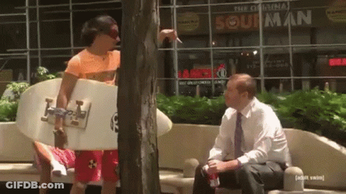 Surfboard Man Talking To Man At Original Sour Man GIF