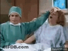 Surgeon Holding Woman's Head GIF