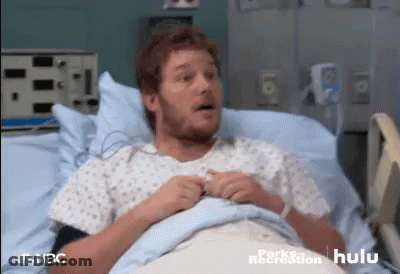 Surgeon In Mask And Gloves Looking At Camera GIF