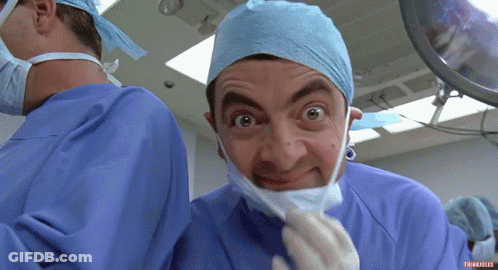 Surgeon In Mask And Gloves Looking At Camera GIF