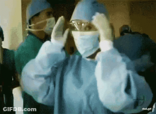 Surgeon In Mask And Goggles Getting Ready GIF