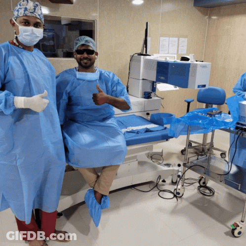 Surgeon Thumbs Up, Another On Operating Table GIF
