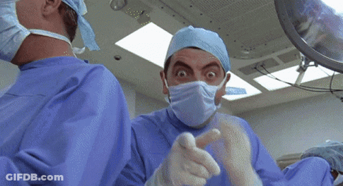 Surgeon With Mask And Gloves Looking At Camera GIF
