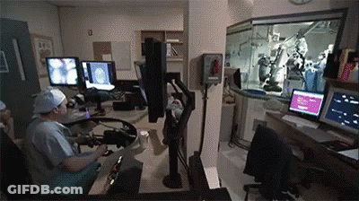 Surgeons Operating On Patient In Operating Room With Clock GIF