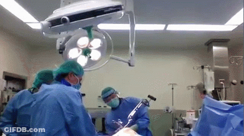Surgeons Performing Surgery On Patient GIF