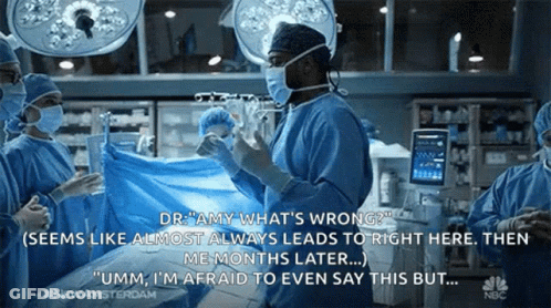 Surgeons Talking Operating Room Wearing Masks And Gloves GIF