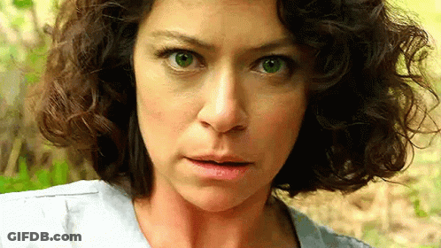 Surprised Curly-Haired Woman Looking At Camera GIF