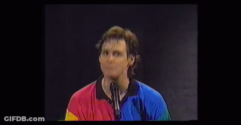 Surprised Man In Colorful Shirt With Hands GIF