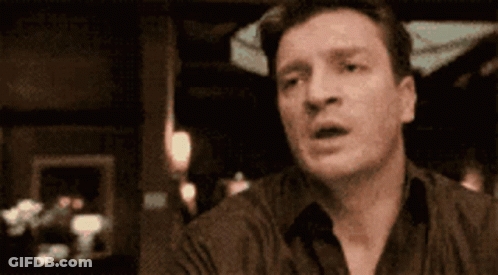 Surprised Man Sitting At Table GIF
