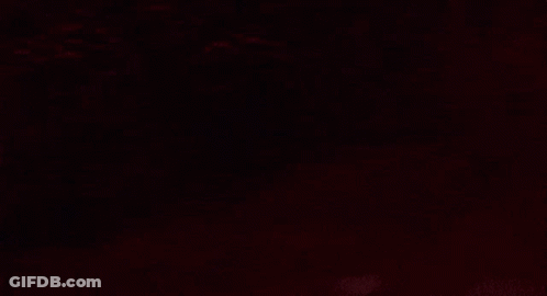 Surprised Man Standing In Dark GIF