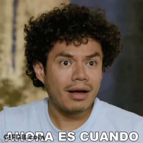Surprised Man With Curly Hair Saying Ahora Es Cuando GIF