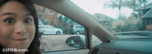 Surprised Woman In Car Looking Out Window GIF